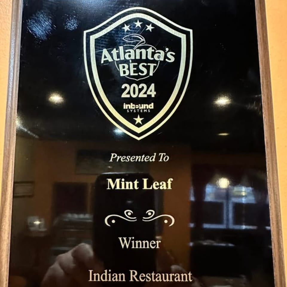 A plaque recognizing Mint Leaf Indian Restaurant as "Atlanta's Best 2024" by Inbound Systems.