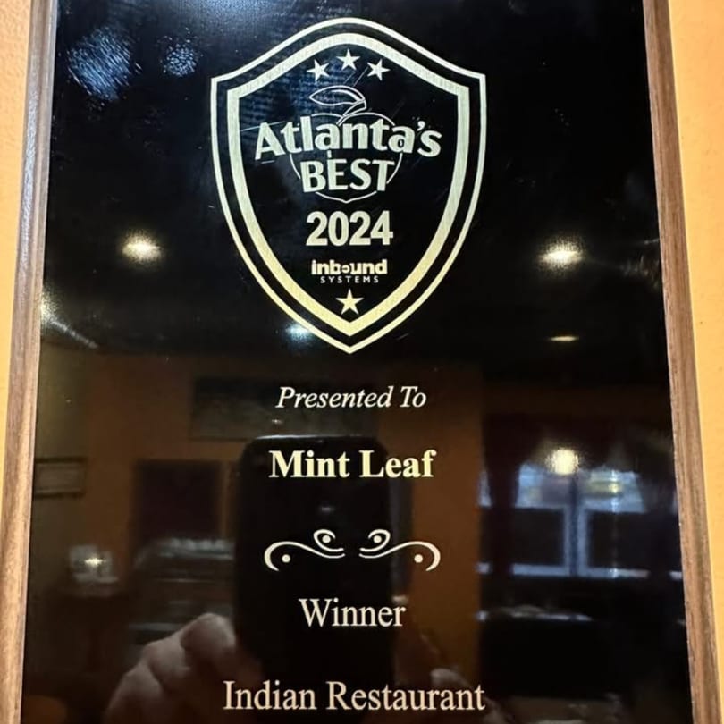 A plaque recognizing Mint Leaf Indian Restaurant as "Atlanta's Best 2024" by Inbound Systems.
