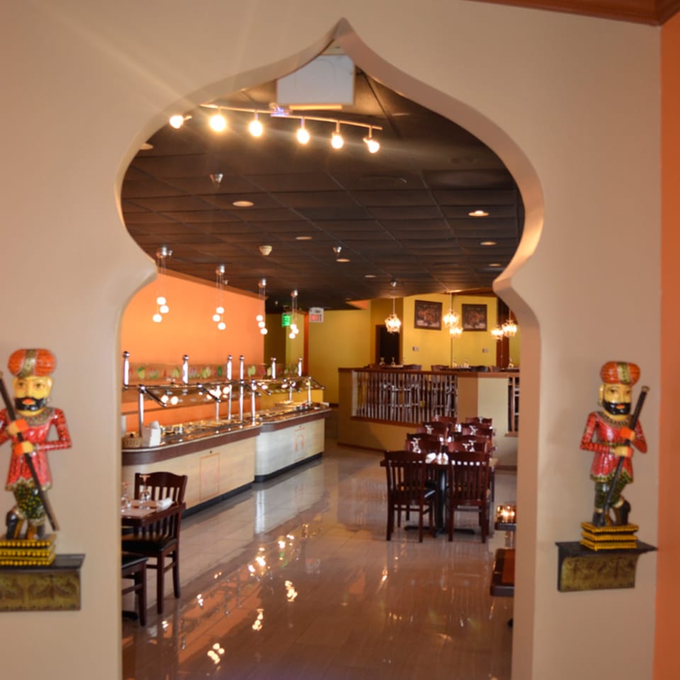 Mint Leaf Indian Cuisine's dining room with a buffet, tables, and traditional Indian decor.