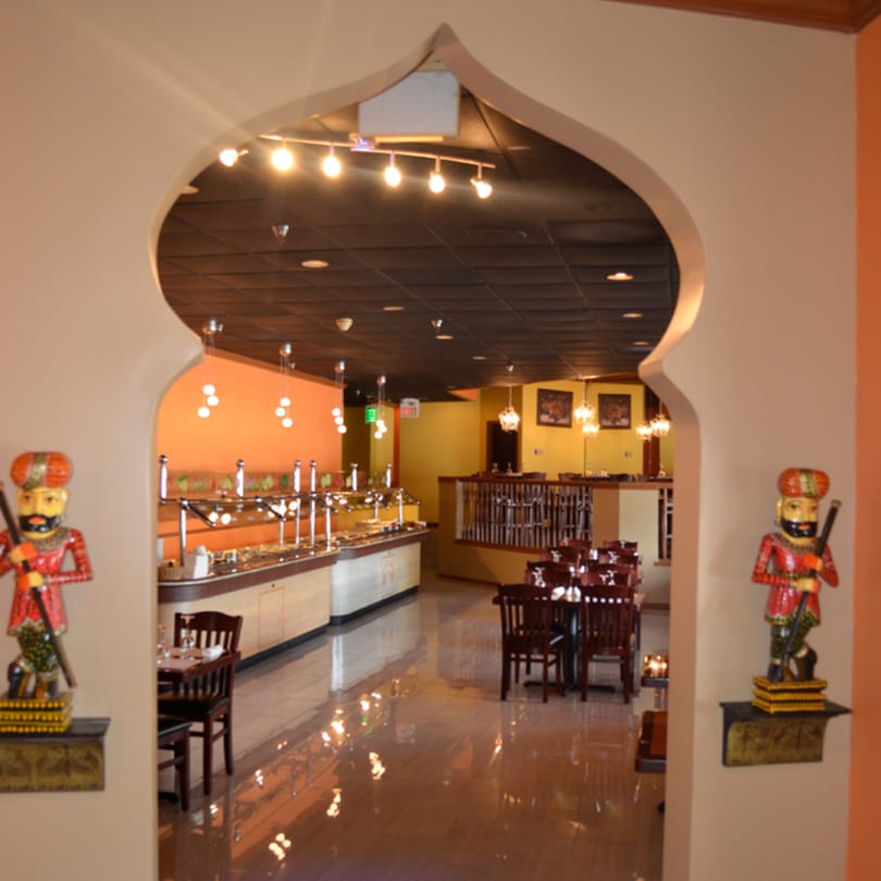 Mint Leaf Indian Cuisine's dining room with a buffet, tables, and traditional Indian decor.