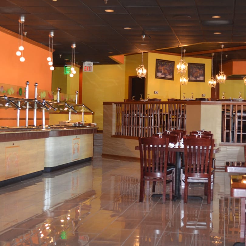 Interior of Mint Leaf Indian Cuisine with a buffet line, dining tables, and warm lighting.